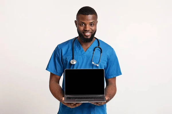 depositphotos_356313676-stock-photo-black-cheerful-surgeon-holding-blank
